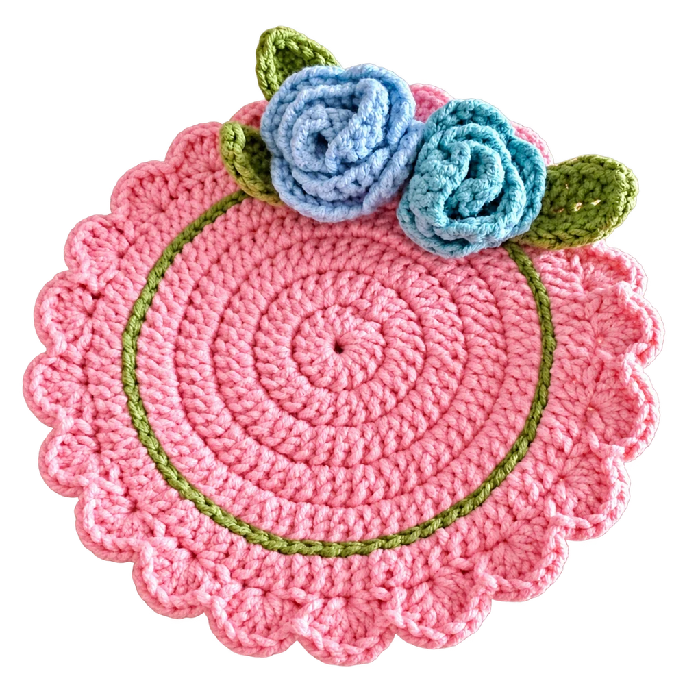 Pink crochet coaster with blue roses and green leaves